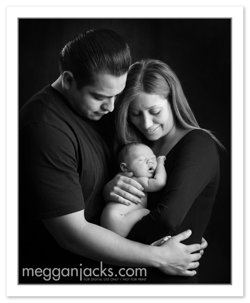 newborn baby with family portrait