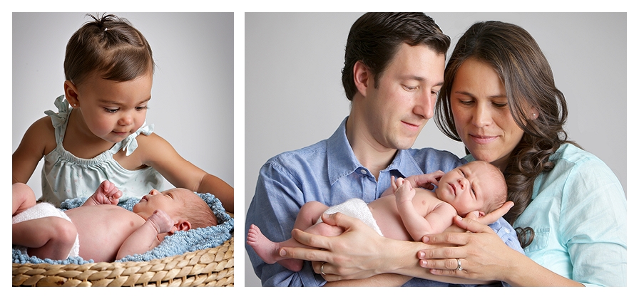 photo of a little girl gazing at her newborn brother, portrait of parents holding their baby boy